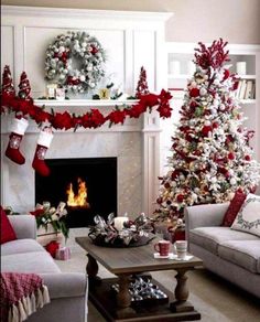 a living room decorated for christmas with red and white decorations