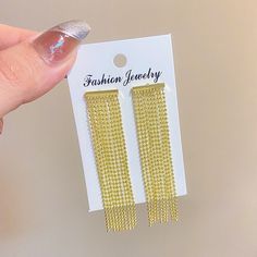 High Fashion Gold Tassel Earrings Eye-catching high fashion tassel earrings Exudes trendy and stylish vibes Geometric design for a unique and modern look Perfect for various occasions such as anniversaries, engagements, parties, and weddings Made of high-quality copper material No allergy, lead, nickel, or cadmium for environmental safety Free standard shipping available for orders over $10 America Fashion, Gold Tassel Earrings, Long Tassel Earrings, Tassels Fashion, Long Fringe, Gold Statement Earrings, Tassel Drop Earrings, Long Fringes, Copper Material