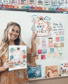 a woman standing in front of a bulletin board