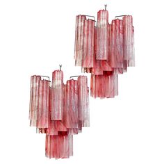 three red glass chandeliers hanging from the ceiling in front of a white background