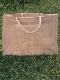 a jute bag sitting in the grass