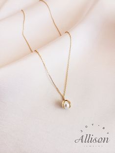 Pearls are used a lot in accessories as gemstones. It looks classy, timeless and elegant, and we agree! However, we try to bring pearl necklaces to a whole new level. Here we present you a necklace with a pendant you've never seen before. Our pendant shows a shell that is opened with a beautiful pearl inside. This is truly a one-of-a-kind piece.  This beautiful necklace is made of 925 sterling silver that is plated with 18K gold. The star of the pendant is a real, freshwater pearl. The length of the necklace is 40 cm while the pendant's length is 2.2 cm. Our jewelry comes with a pouch for safekeeping. A wonderful gift option for a lover, mother, or daughter. Show how much you care by giving them this amazing necklace. A beautiful piece to symbolize beauty, elegance, and class. Suitable for Minimalist Clavicle Chain Charm Necklace For Formal Occasions, Minimalist Formal Charm Necklace With Clavicle Chain, Minimalist Formal Charm Necklace With Clavicle Style, Elegant Rose Gold Charm Necklaces For Everyday, Elegant Everyday Teardrop Pendant Jewelry, 14k Gold Filled Clavicle Chain With Round Pendant, Elegant 14k Gold Clavicle Chain Charm Necklace, Minimalist Pendant Charm Necklace For Formal Occasions, Minimalist Pendant Charm Necklace For Formal Events