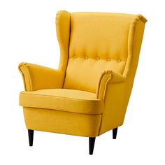 an upholstered yellow chair with buttons on the armrests and back rests against a white background