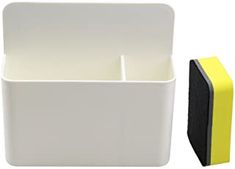 a square candle holder next to a yellow and black block