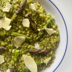 a white plate topped with green beans and asparagus covered in parmesan cheese