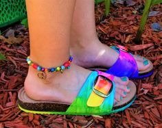 Be Soleful! Tie-Dye Birkenstock-style adjustable buckled slide sandals -perfect for the hippie chick! Be bright, be bold, and be colorful in these super comfy and cute tie-dye slide sandals! Available in women's sizes 7-10. **Please note these are NOT the Birkenstock brand - they are made from high quality shoe that are just as cute and comfy** Multicolor Adjustable Sandals, Multicolor Adjustable Strap Sandals, Adjustable Buckle Closure Comfortable Flip Flops, Adjustable Multicolor Flip Flops For Spring, Colorful Adjustable Sandals For Spring, Fun Adjustable Sandals For Spring, Adjustable Fun Sandals For Spring, Bohemian Sandals With Buckle Closure And Adjustable Fit, Spring Flip Flops With Adjustable Strap