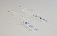 "These light blue Swarovski dainty threader earrings are handcrafted by me. Perfect gift for bridesmaid pr prom jewelry! Handcrafted by me by wire wrapping Lt Sapphire AB  Swarovski crystal 4mm bicones to sterling silver threader ear wires. These earrings are not just stunning and fashionable but they are very comfortable to wear. The earrings dangle approximately 2 3/4\" from your earlobe. I use the threaders with the \"U\" in them, which sit nicely and securely in your earlobe. Click on the li Daughter Bridesmaid, Bloodstone Jewelry, Silver Threader Earrings, Blue Dangle Earrings, Light Sapphire, Prom Jewelry, Threader Earrings, Blue Jewelry, Sapphire Earrings