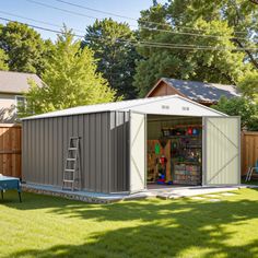 a backyard shed is shown with the door open and it's in the grass