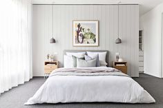 a bedroom with white walls and gray carpet