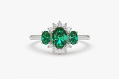 "Emerald Ring / 14k Three Stone Emerald Cluster Ring / Classic Emerald Engagement Ring 14k Gold / May Birthstone / Promise Ring Black Friday Ferkos Fine Jewelry Features *Made to Order *Gold Kt: 14K (also available in 18K) *Available Gold Color: Rose Gold, Yellow Gold, White Gold *Oval Shape Emerald: 1 pc 6 x 4MM *Oval Shape Emerald: 2 pc 4x3MM *Round Diamonds: 10 pcs 1.55 MM *Sapphire CTW: 0.90 ctw *Diamond CTW: 0.16 ctw *Ready to Ship in 7-10 Business Days If you have any additional questions Emerald Cluster Ring With Halo For Anniversary, Green Center Stone Ring In 14k White Gold, Green 14k White Gold Ring With Center Stone, Emerald Cluster Ring With Accent Stones, Round Cut, Emerald Cluster Ring With Accent Stones, 14k White Gold Gemstone Ring For May Birthstone, May Birthstone Cluster Ring With Gemstones, Gemstone Cluster Ring For May Birthstone, Cluster Ring With Center Stone In Emerald