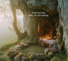 a table is set up in the middle of a cliff with flowers and candles on it