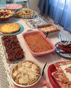 a table topped with lots of different types of pies and other foods on top of it