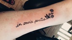 a person with a tattoo on their arm that says in roma parvatita and flowers