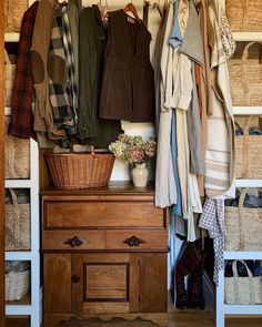 an organized closet with clothes and baskets