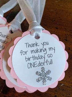 two tags that say thank you for making my birthday so onederful with snowflakes on them