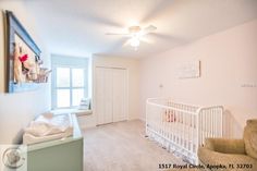 a baby's crib in the corner of a room with white walls and carpet