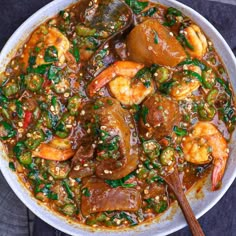 a white bowl filled with shrimp and vegetables