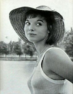 an old photo of a woman wearing a hat