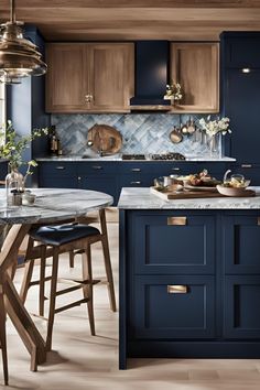 a kitchen with dark blue cabinets and marble counter tops, an island in the middle