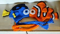 two crocheted hats with fish faces on them