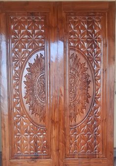 two wooden doors with intricate carvings on the front and side panels, both made out of wood