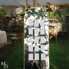 an outdoor wedding reception setup with seating cards