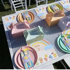 the table is set with colorful plates and place settings for children's birthdays