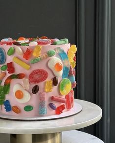 a pink cake with gummy bears on it