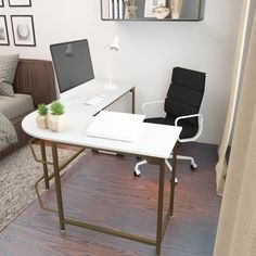 a computer desk with a laptop sitting on top of it next to a chair and couch