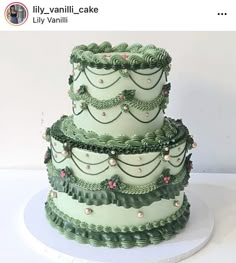 there is a three layer cake with green icing on the top and bottom tier