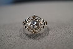 I am offering you this vintage sterling silver, wedding band stacker design ring. It features an oval shaped prong set genuine white topaz stones This stone is set in a scrolled single stone setting. There is fabulous raised relief design work here. It is measuring app. 3/4 inch, by app. 1/2 inch. It is currently a size 8 , though I am sure it could be sized up or down. It weighs app. 4.5 grams. Look at the detail of the design work of this vintage ring Simply breathtaking. This ring came out of Classic Oval Topaz Ring For Anniversary, Diamond White Oval Topaz Ring For Anniversary, Silver Oval Bezel Setting Wedding Rings, Anniversary Oval Topaz Ring In Diamond White, Anniversary Oval Diamond White Topaz Ring, Anniversary White Topaz Oval Rings, Classic Oval Sterling Silver Topaz Ring, White Oval Topaz Ring For Anniversary, Classic Oval Topaz Wedding Ring