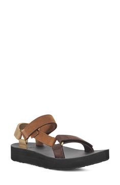 An edgy mash-up of the brand's Original Universal and Flatform Universal sandals, this leather version delivers sporty style with an upgraded look. 1 1/4" heel; 1" platform; 1/4" slope (size 9) Adjustable straps with hook-and-loop closures EVA foam-cushioned footbed Leather upper and lining/rubber sole Imported Modern Leather Sport Sandals With Round Toe, Brown Leather Sport Sandals With Round Toe, Modern Leather Platform Sport Sandals, Brown Leather Platform Sport Sandals, Brown Leather Sport Sandals For Spring, Leather Platform Sport Sandals, Brown Leather Sport Sandals With Textured Footbed, Sporty Leather Platform Sport Sandals, Sporty Leather Platform Sandals