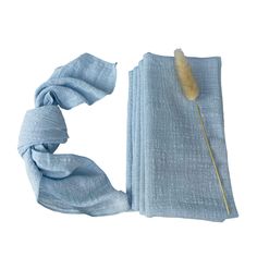 a blue scarf with a feather on it and a piece of fabric wrapped around it