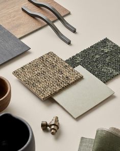 various materials are laid out on the table to be used as wallpaper or floor coverings