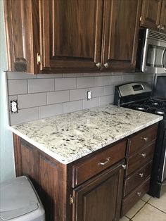 a kitchen with granite counter tops and wooden cabinets