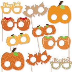 an assortment of pumpkins and glasses on sticks