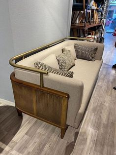 a beige couch sitting on top of a hard wood floor