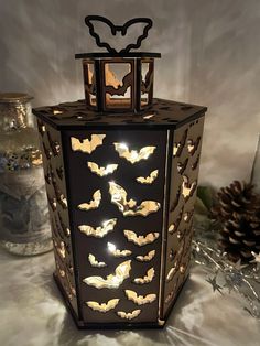 a decorative lantern with bats on it