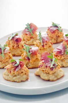 small appetizers are arranged on a white plate