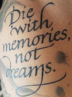 a close up of a person's chest with writing on it that says die with memories, not dreams