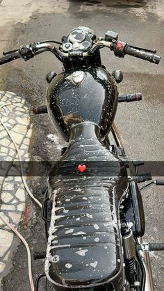 a black motorcycle parked on top of a street