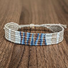 a close up of a bracelet on a wooden surface