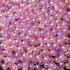 many pink beads are scattered together on the ground