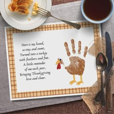 there is a turkey handprint on a place mat next to a cup of coffee