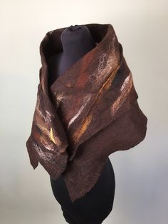 This beautiful soft hand felted wool Stole is Made from fine quality merino wool. Using the wet felting technique the wool is felted onto fine cotton Musiln , and is blended with autumnal colours and natural fibres such as flax , silk , and hemp fibres. THIS BEAUTIFUL STOLE IS ON OFFER AS PART OF MY SPRING CLEANSE CAMPAIGN. AS I HAVE HAD ALL MY SHOW , EXHIBITIONS ,MARKETS AND FESTIVALS CANCELLED FOR THSI YEAR SO FAR , AND ALL THE SHOPS ARE CLOSED ,I HAVE DECIDED TO DO A SPRING CLEAN OF MY STUDIO Handmade Brown Shawl For Fall, Brown Wool Shawl One Size, Brown Wool Shawl, One Size Brown Wool Shawl, Brown One-size Wool Shawl, Spring Cleanse, Winter Shawl, Types Of Cakes, Boho Accessories