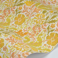 an orange and yellow wallpaper with flowers on white background, closeup shot from the neck down