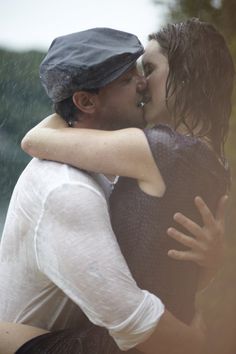 two people embracing each other in the rain