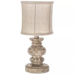 a lamp that is sitting on top of a wooden base with a linen shade over it