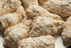 a white plate topped with cookies covered in powdered sugar