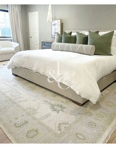 a large bed sitting on top of a white rug